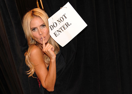 Behind the scene at the victoria secret fashion show with Heidi Klum playfully showing us a Do Not Enter Sign
