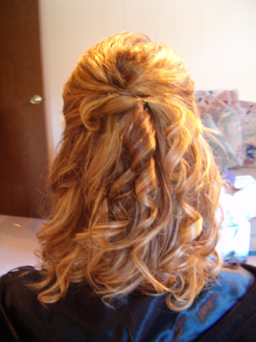 This is a gorgeous prom hairstyle shown here on blonde hair tied half way up.