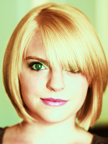 Here is a blond girl with green eyes wearing a new short hairstyle
